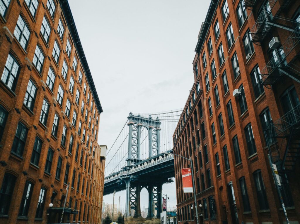 The Manhattan Bridge framed by brick buildings on Washington Street in DUMBO, Brooklyn
