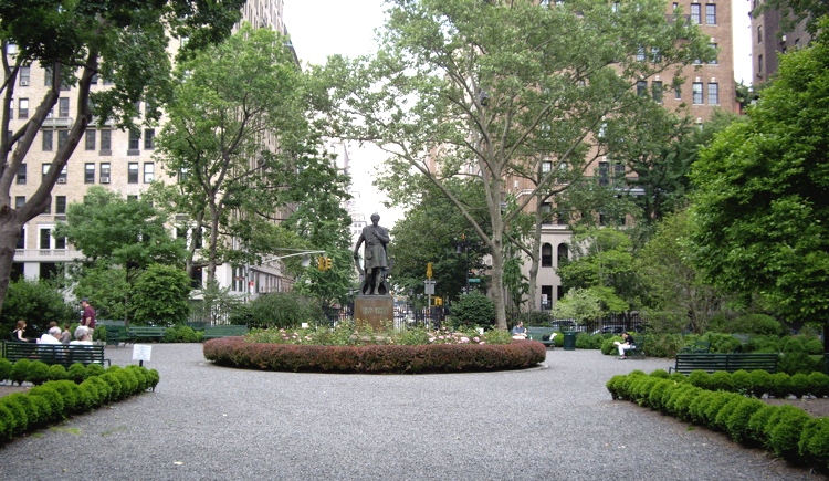 Inside Gramercy Park: gravel paths, clipped hedges and the statue of Edwin Booth in a ring of flowers