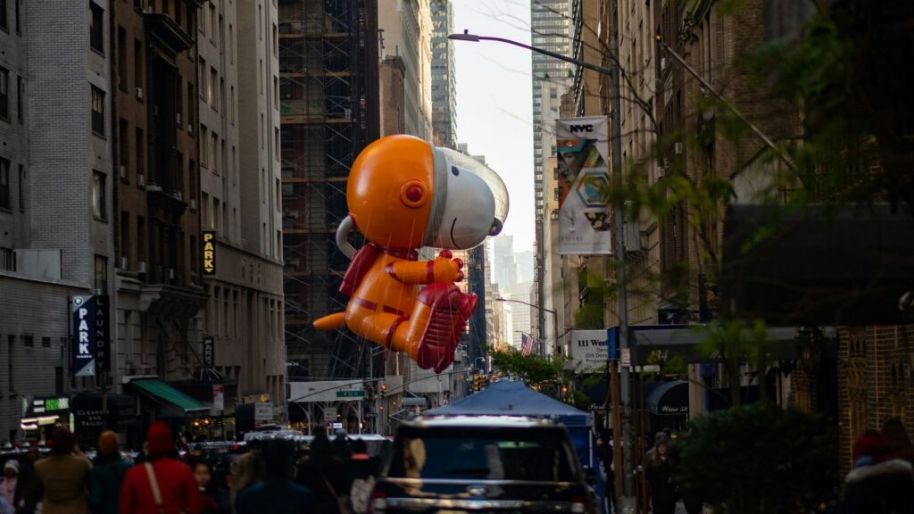 Giant Snoopy balloon floating over the crowd at the Macy's Thanksgiving Day Parade in New York City