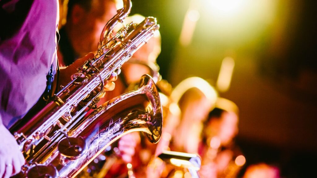 Jazz musicians performing on stage with colorful stage lighting at a live jazz club
