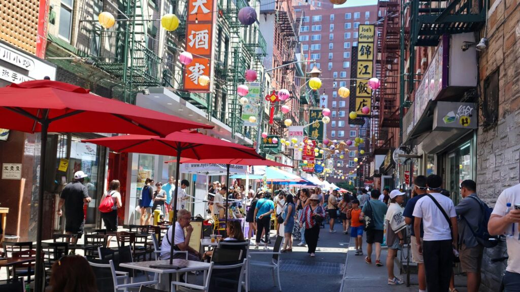 Colorful street scene in Manhattan's Chinatown, New York City, with lanterns and storefronts