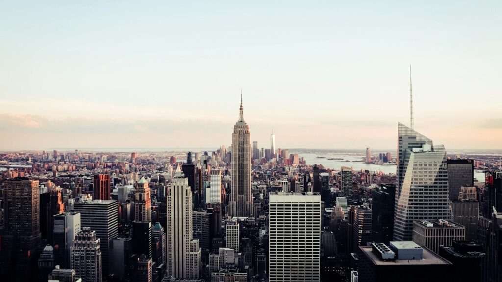 The Manhattan skyline from above, showing the Empire State Building surrounded by skyscrapers — the backdrop to the city's hidden pocket parks