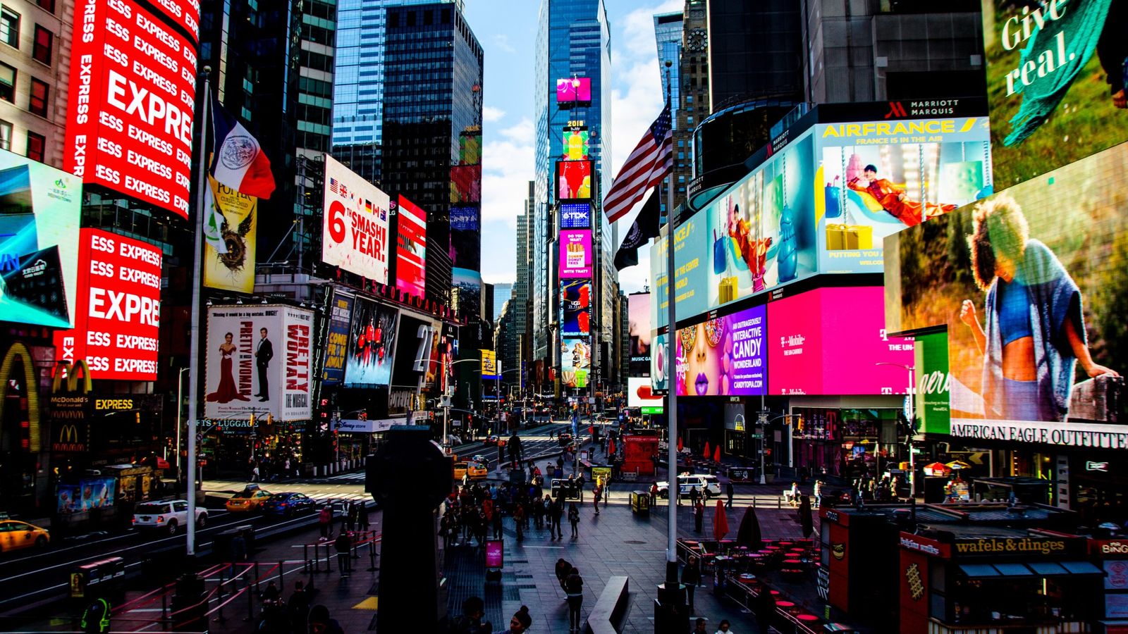 Times Square illuminated at night in New York City, the heart of Manhattan