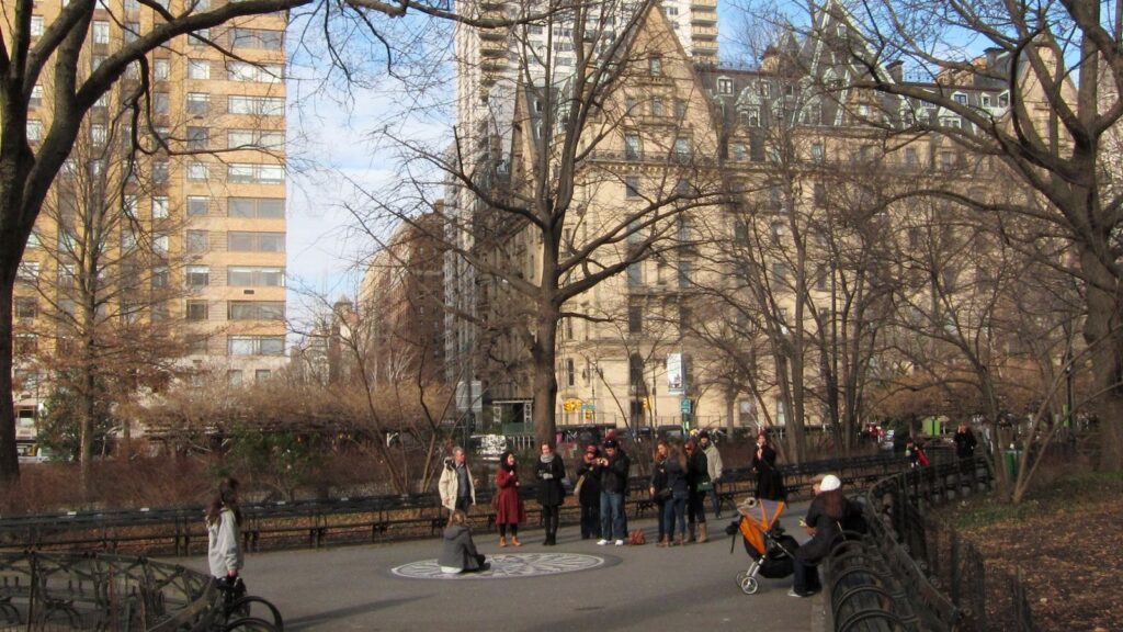 The Strawberry Fields memorial in Central Park, New York City, with the Dakota building visible through the trees