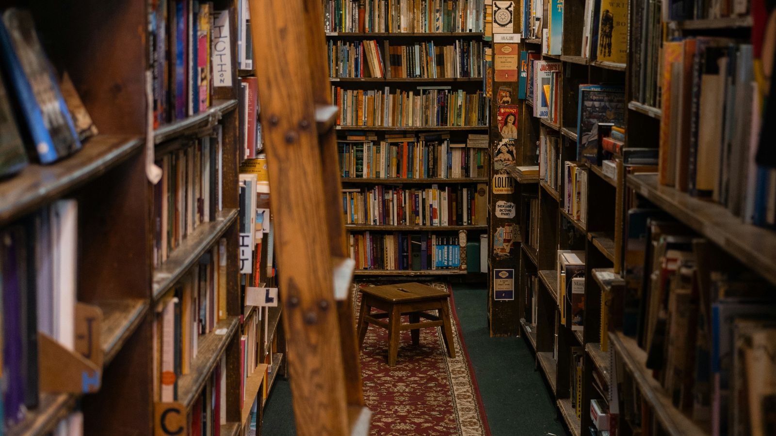 Floor-to-ceiling bookshelves inside a New York City bookstore, packed with thousands of second-hand and new books