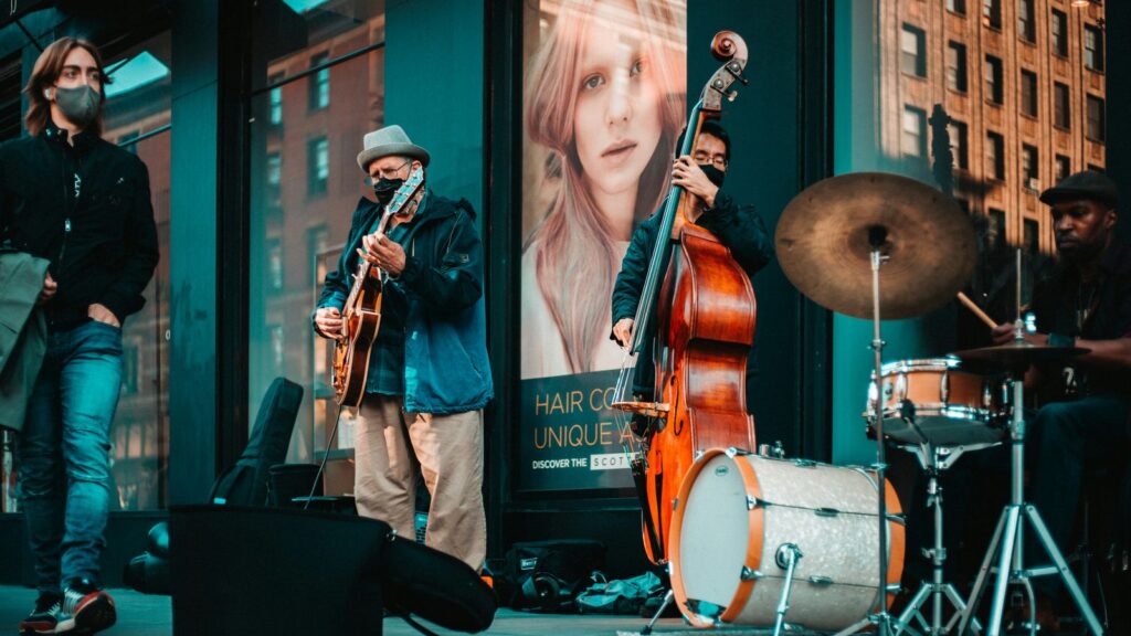 Musicians performing jazz on a New York City street, with crowds gathered to listen