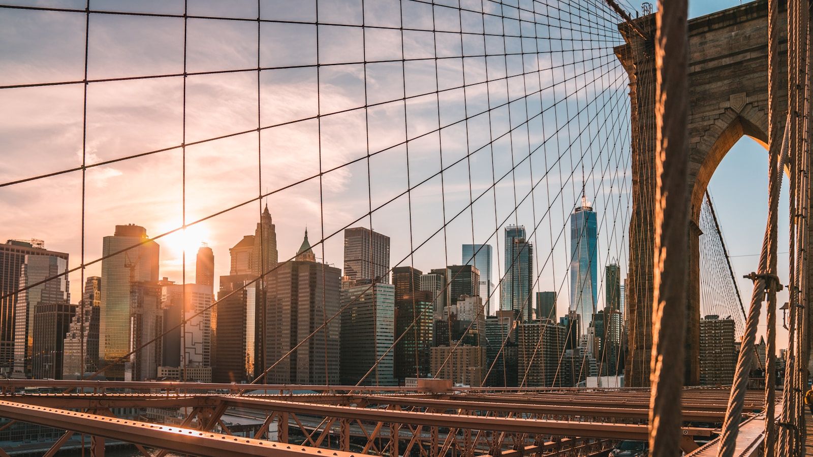 The Manhattan skyline glowing at golden hour, as seen from across the water — the iconic view from the Staten Island Ferry