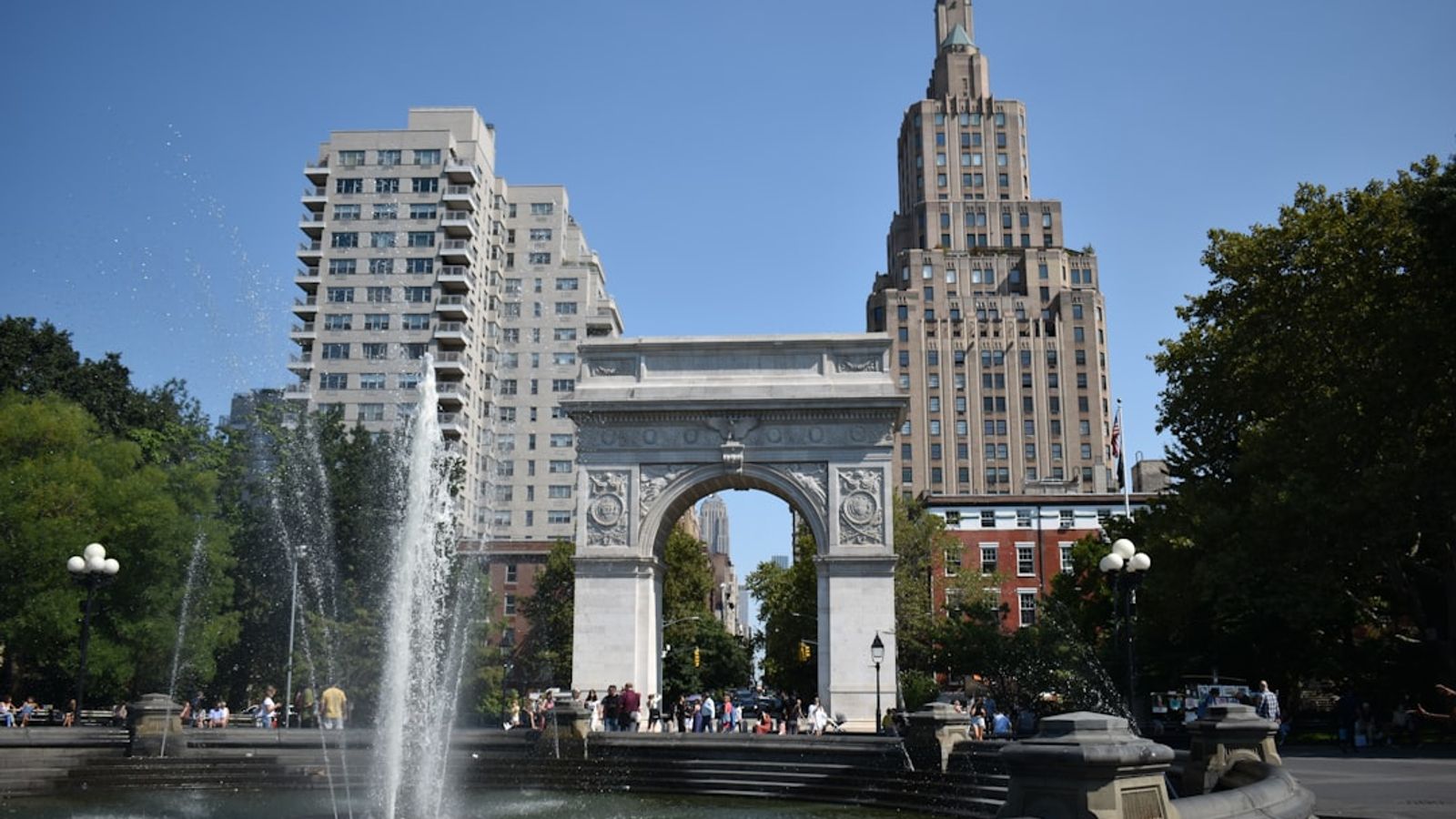 Washington Square Park with iconic marble arch and fountain, Manhattan buildings in background