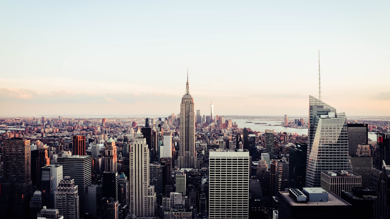 The Manhattan skyline at dusk, looking south from upper Manhattan toward Midtown, with the Empire State Building at centre