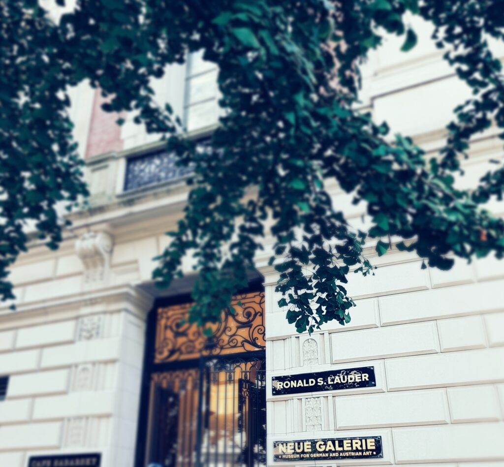The ornate iron entrance gate and Neue Galerie name plaque on the museum's Fifth Avenue mansion