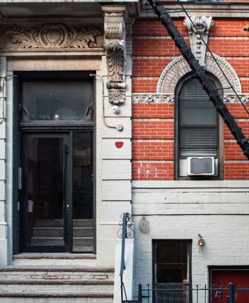 Classic red brick residential buildings on a quiet Brooklyn neighbourhood street, typical of Greenpoint's Polish immigrant architecture
