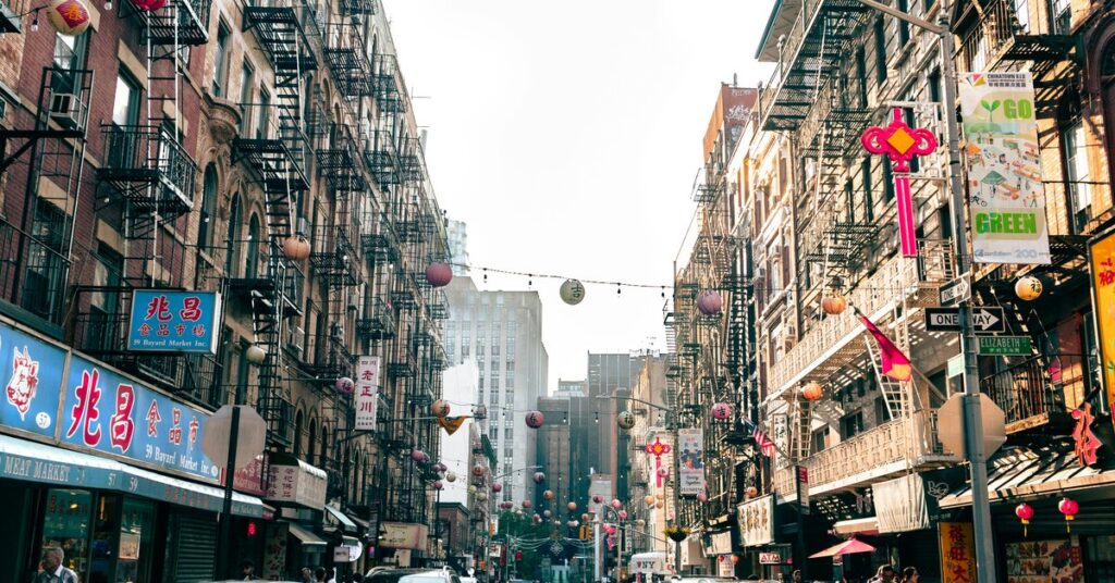 Mott Street in New York City Chinatown with red lanterns strung between buildings