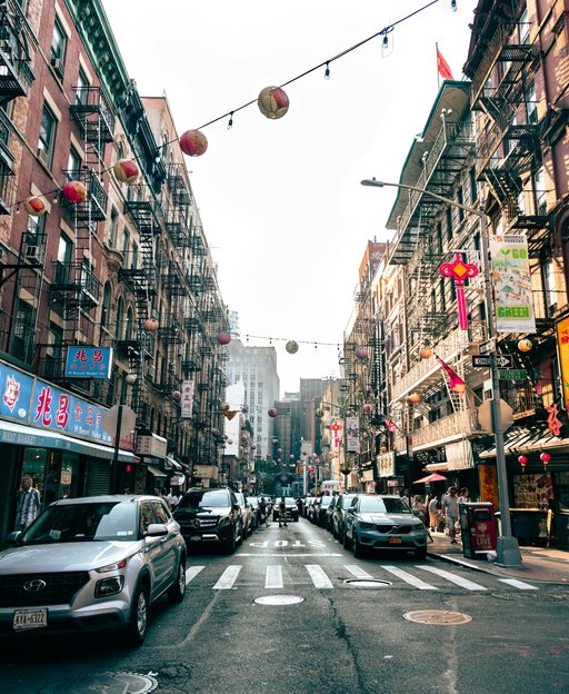 Mott Street in New York City Chinatown with red lanterns strung between buildings