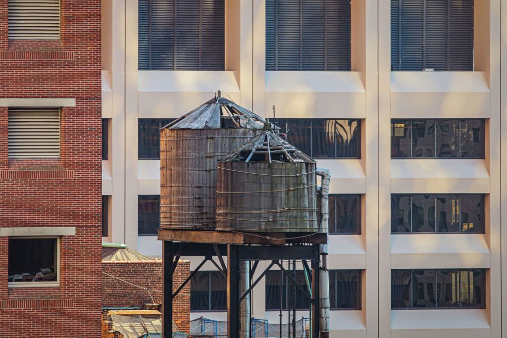 Weathered wooden water towers on a New York rooftop
