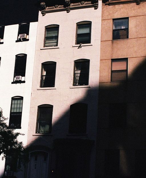Classic New York City apartment buildings with fire escapes on a neighbourhood street in the South Bronx