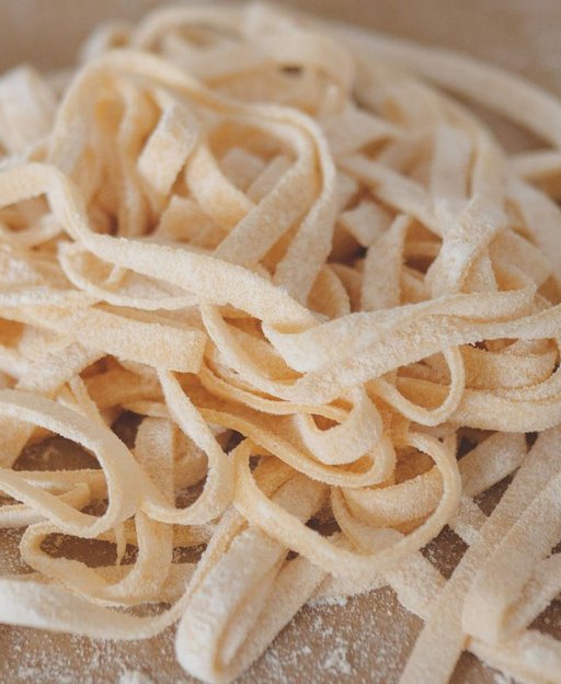 Fresh homemade pasta on a flour-dusted surface, representing the Italian culinary tradition of Arthur Avenue in the Bronx