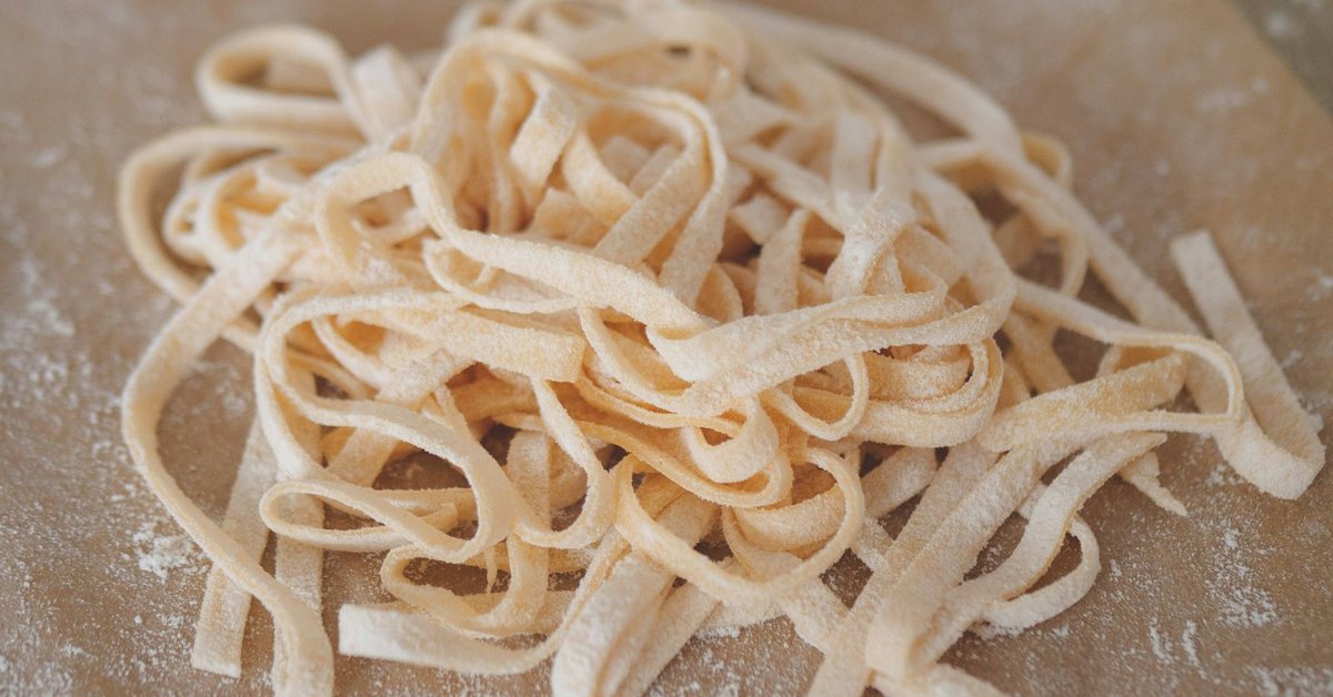 Fresh homemade pasta on a flour-dusted surface, representing the Italian culinary tradition of Arthur Avenue in the Bronx