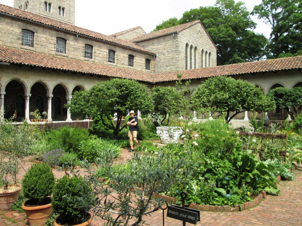 The herb garden and stone arcades of the Bonnefont Cloister at The Met Cloisters