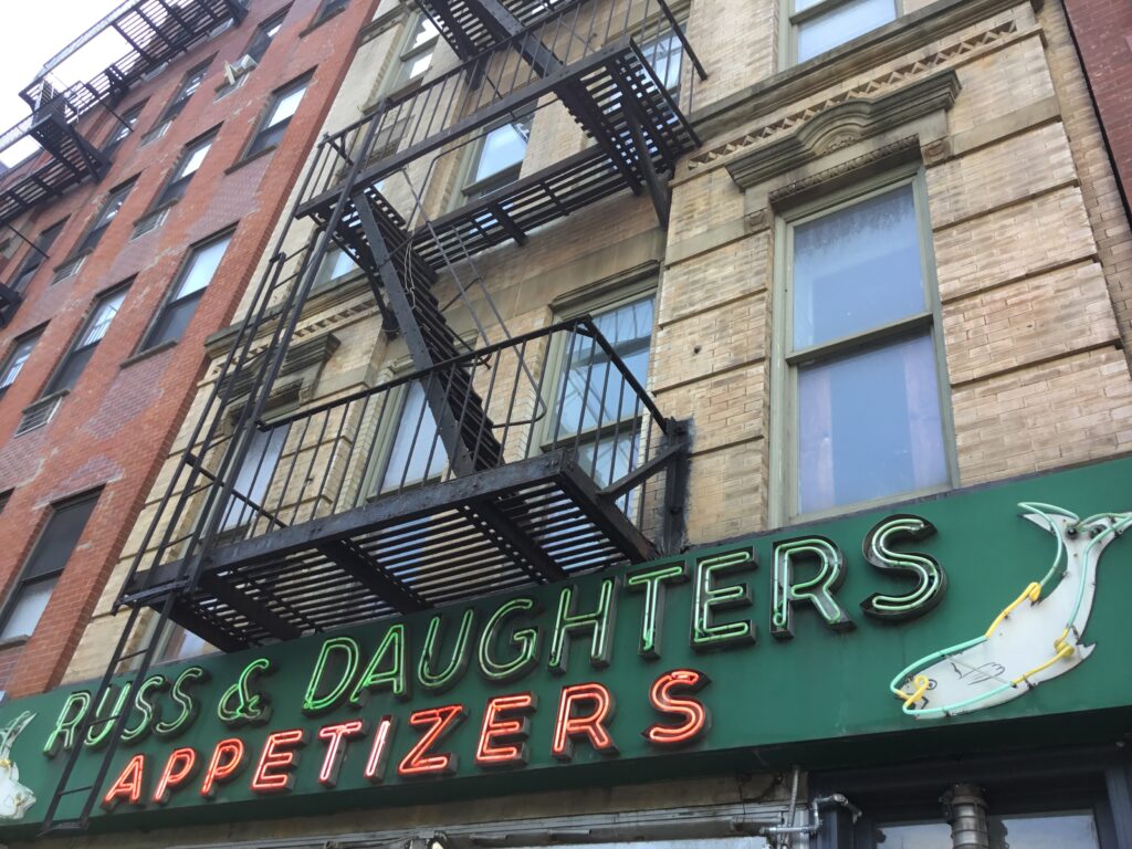The green neon Russ & Daughters Appetizers sign above the shop on the Lower East Side