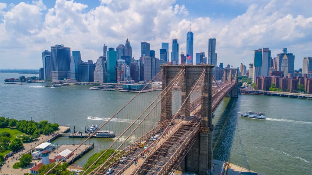 Aerial view of the Brooklyn Bridge crossing the East River to the Lower Manhattan skyline