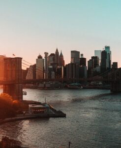 DUMBO Brooklyn with the iconic Manhattan Bridge framed between the buildings on Washington Street at dusk, one of New York Citys most romantic viewpoints