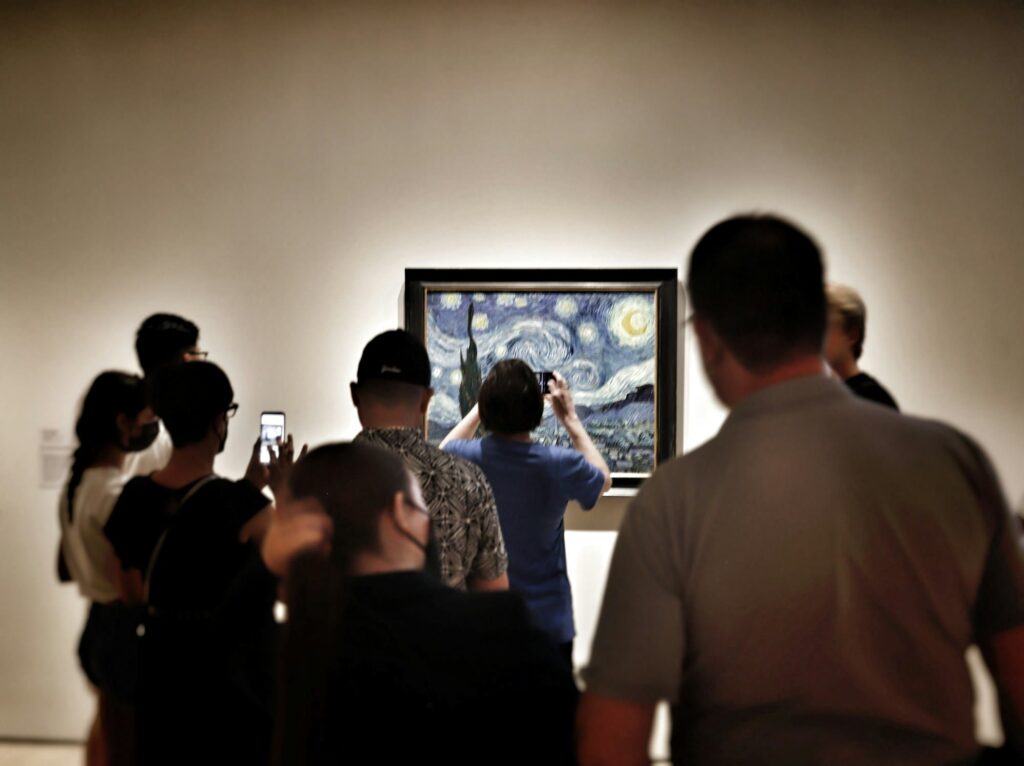 Visitors gathered with their phones in front of Van Gogh’s The Starry Night in a MoMA gallery