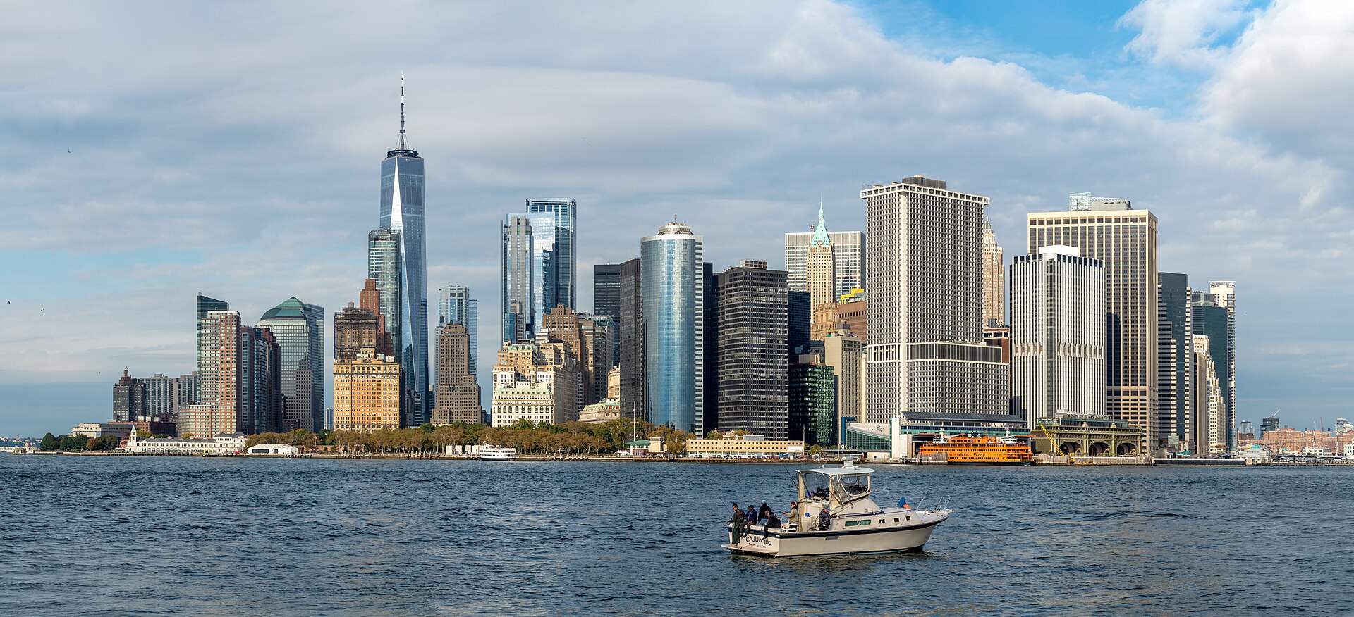 Lower Manhattan skyline seen from Governors Island with a fishing boat in the foreground