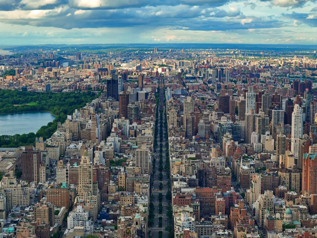 Aerial view north over the Upper East Side, with tree-lined Park Avenue running through the middle and Central Park and its reservoir on the left