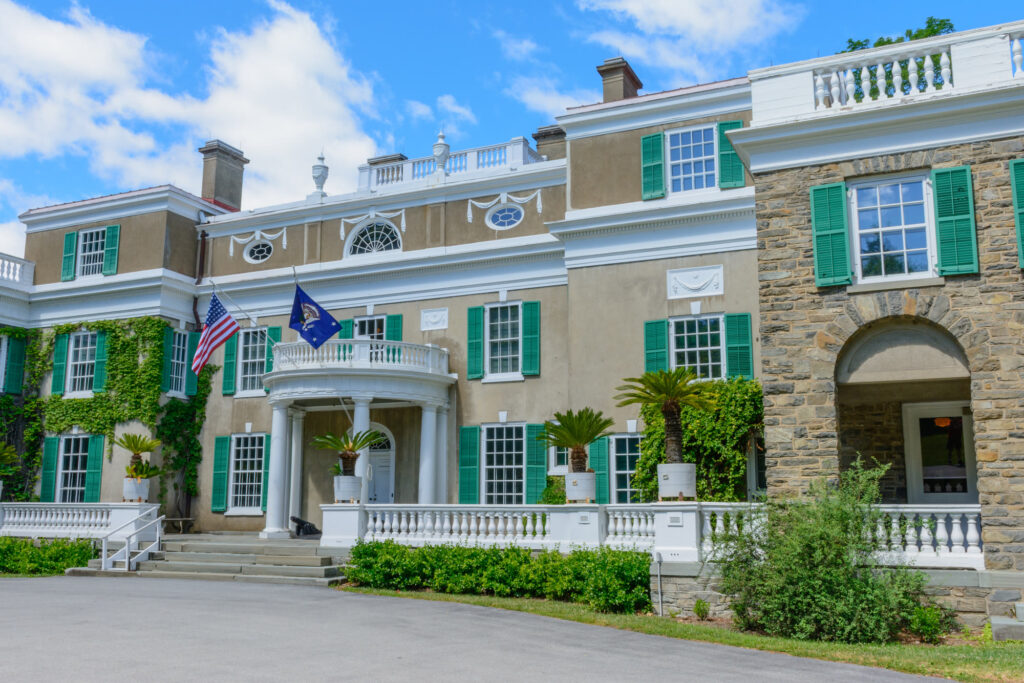 Springwood, Franklin D. Roosevelt's home at Hyde Park, with green shutters, a curved portico and flags flying