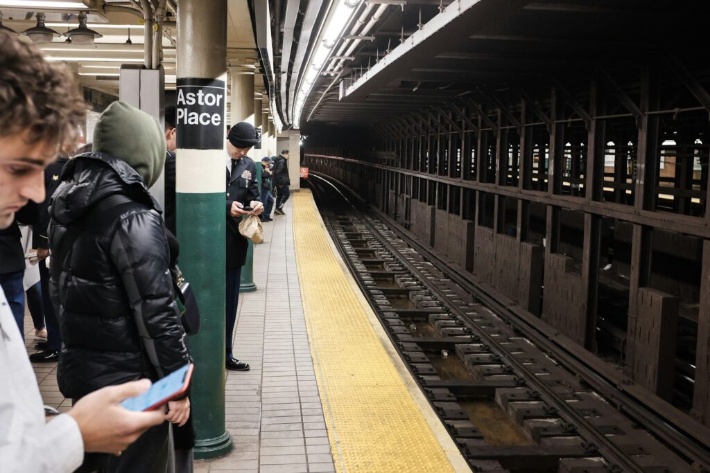 Passengers waiting on the Astor Place subway platform in New York
