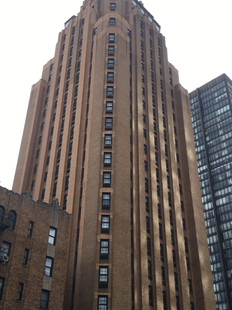Looking up the stepped tan-brick Art Deco Beekman Tower, whose top floor holds the Ophelia lounge