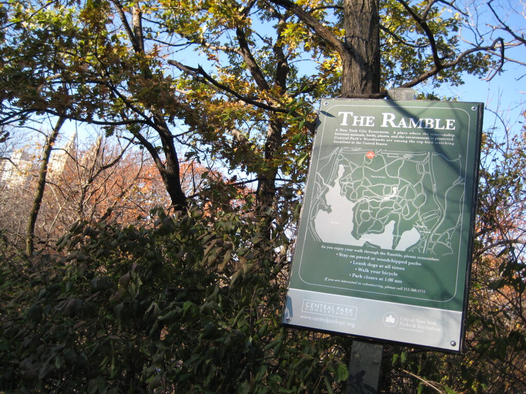 The Ramble sign and map among oak trees and fall leaves in Central Park