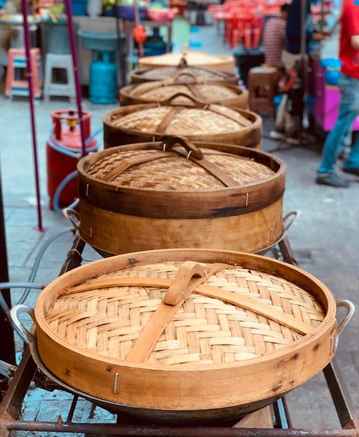 Bamboo dim sum steamers stacked at a restaurant in New York City Chinatown