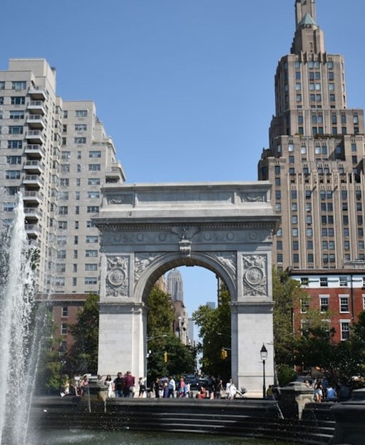 Washington Square Park in Greenwich Village, New York City, with the iconic marble arch on a sunny day