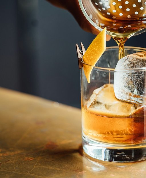 A well-crafted cocktail with ice and citrus garnish at a New York City bar