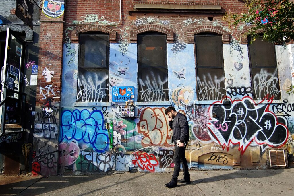 Graffiti-covered walls along a Brooklyn street