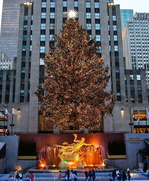 The Christmas tree above the ice rink and golden Prometheus statue at Rockefeller Center, New York City