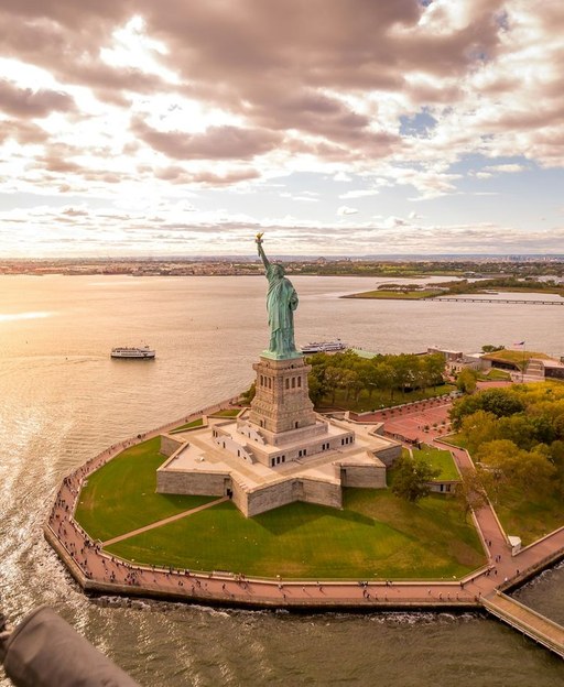 Aerial view of the Statue of Liberty and Liberty Island in New York Harbour at sunset
