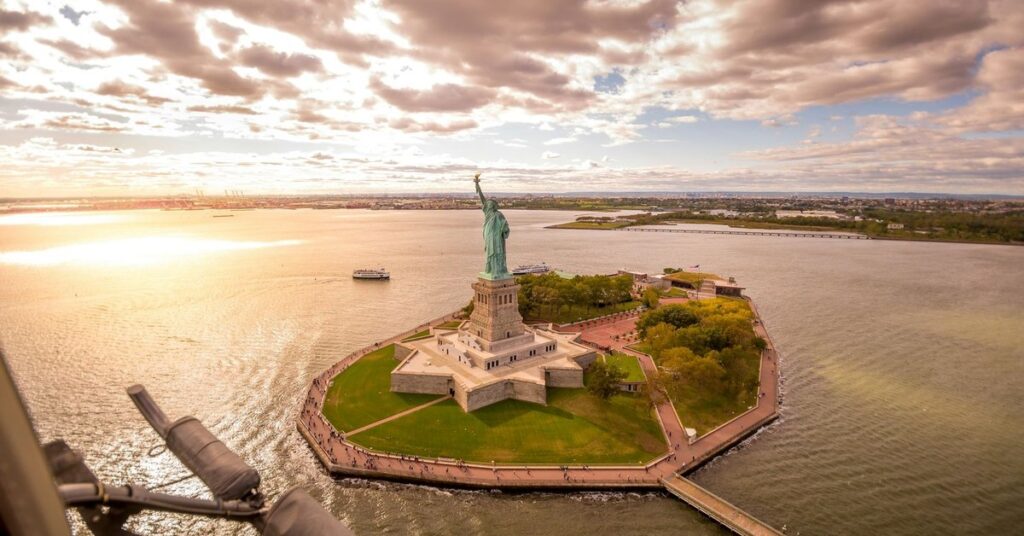 Aerial view of the Statue of Liberty and Liberty Island in New York Harbour at sunset