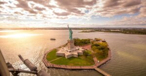 Aerial view of the Statue of Liberty and Liberty Island in New York Harbour at sunset