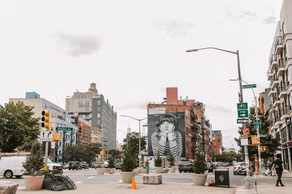 Bedford Avenue street signs and a large black-and-white mural near the Williamsburg Bridge
