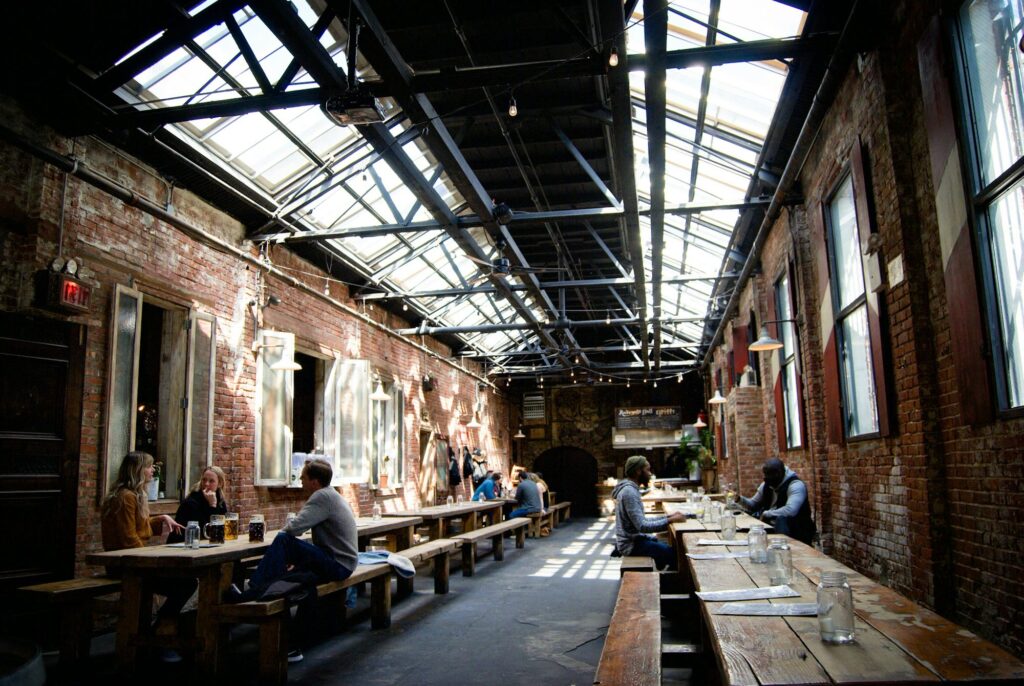 Long wooden tables under the glass roof of the Radegast Hall beer garden