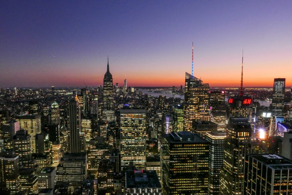 The Empire State Building and the lit Midtown skyline at dusk, seen from Top of the Rock